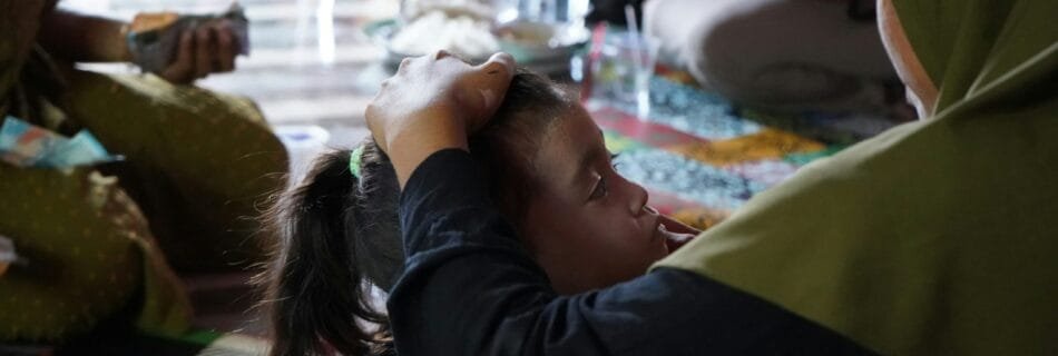 A group of people sitting around each other